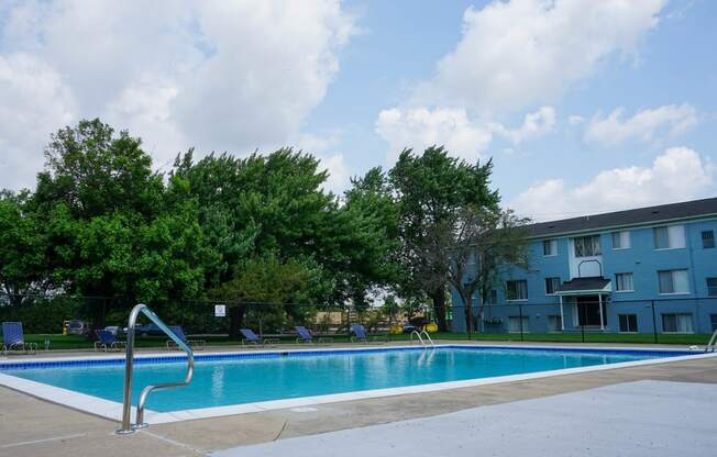 Resort Style Swimming Pool with pool chairs and easy entry, at Gale Gardens Apartments