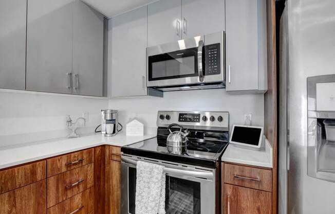 a kitchen with stainless steel appliances and a microwave