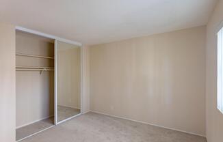 an empty living room with a closet in it
