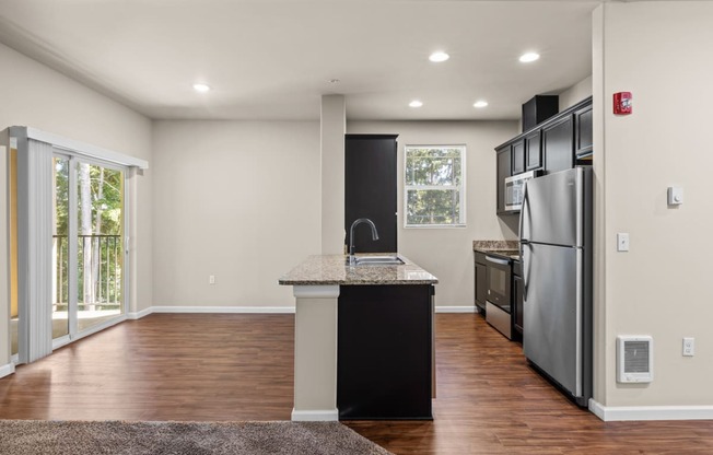 an empty kitchen with stainless steel appliances and a counter top
