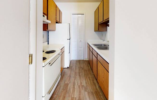 a kitchen with hard-surface floors and white appliances