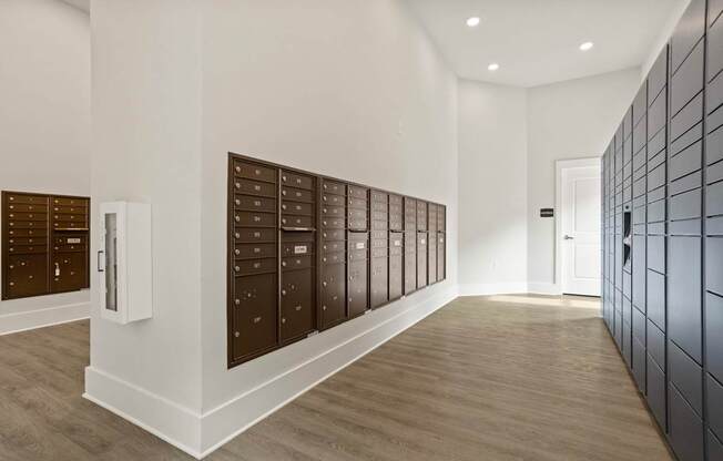 A hallway with a row of mailboxes on the wall.