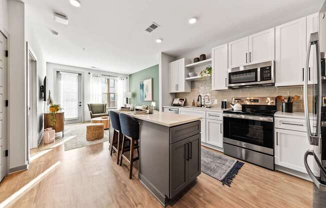 A modern kitchen with a large island and stainless steel appliances