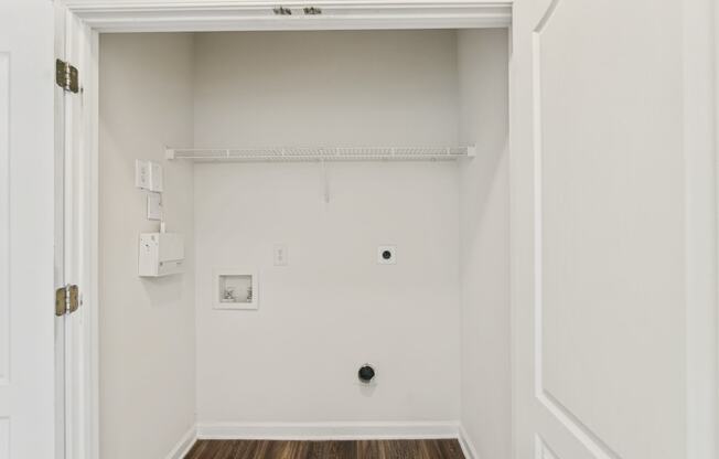 an empty room with a white wall and a white door