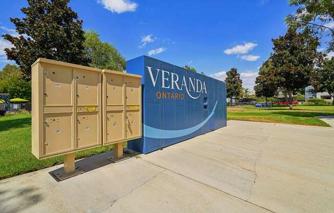 A large sign that says Veranda Ontario stands in front of a row of portable toilets.