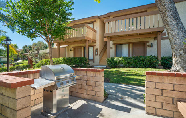 a barbecue grill in front of a house