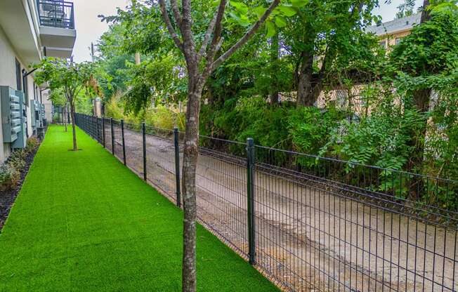a chain link fence with a grassy area next to it