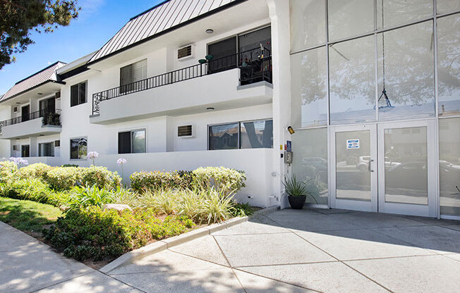 Entrance to National Apartments with drought-resistant greenery.