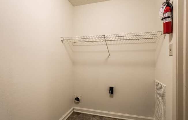 an empty closet with a fire extinguisher on the wall at Pheasant Run in Lafayette, IN 47909