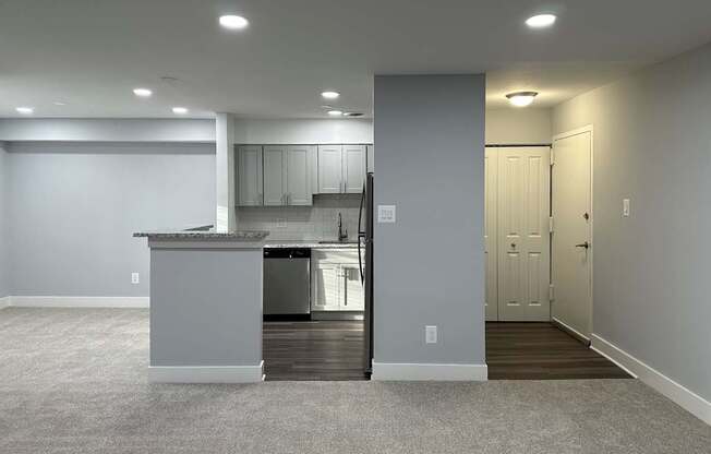 A kitchen with a white countertop and a white refrigerator is visible.