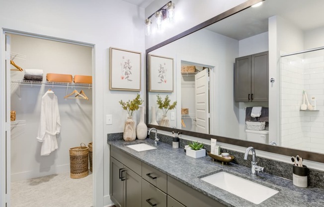 a bathroom with two sinks and a large mirror