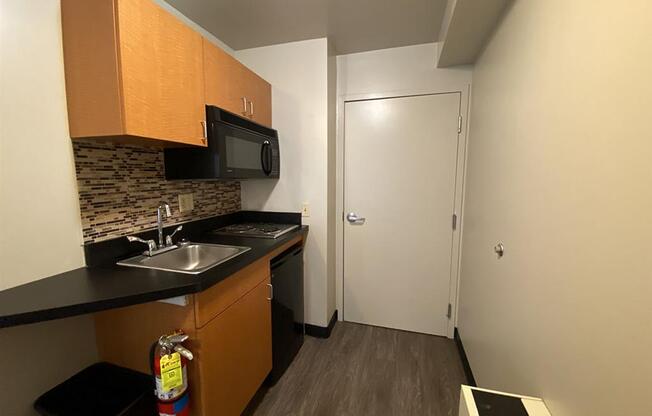 a small kitchen with a sink and a microwave