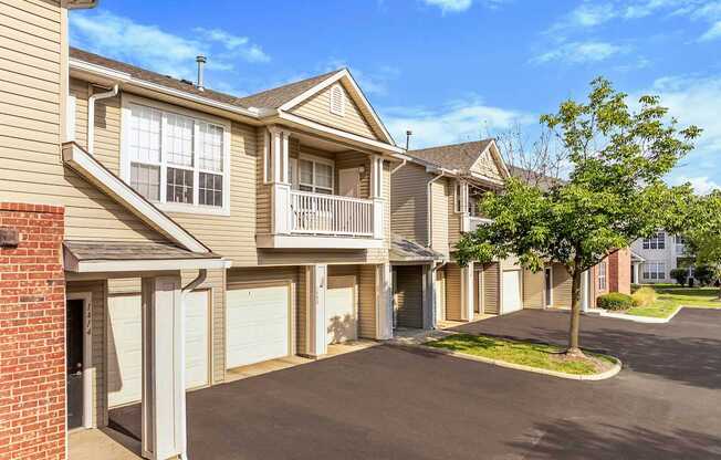 a row of town homes with garages and trees