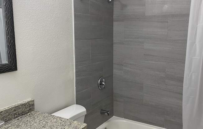 a bathroom with a sink toilet and bathtub at Colonial Apartments, Florida