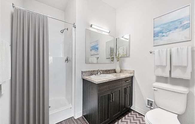 A second bathroom with a sink, toilet, and shower at Trade Winds Apartment Homes, Elkhorn, Nebraska