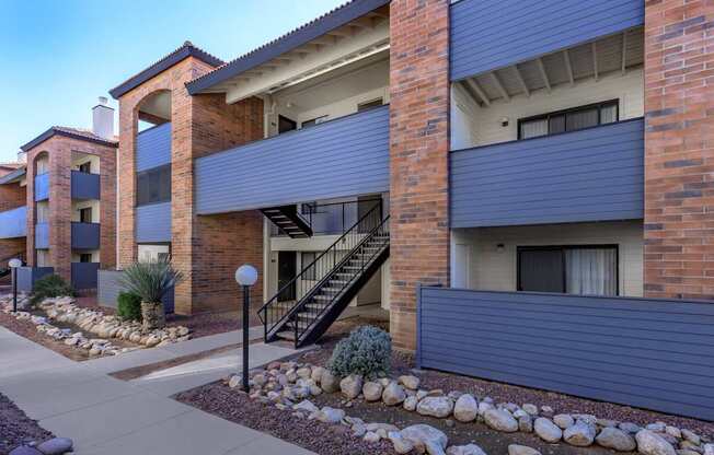 A modern apartment building with a staircase leading to the second floor.