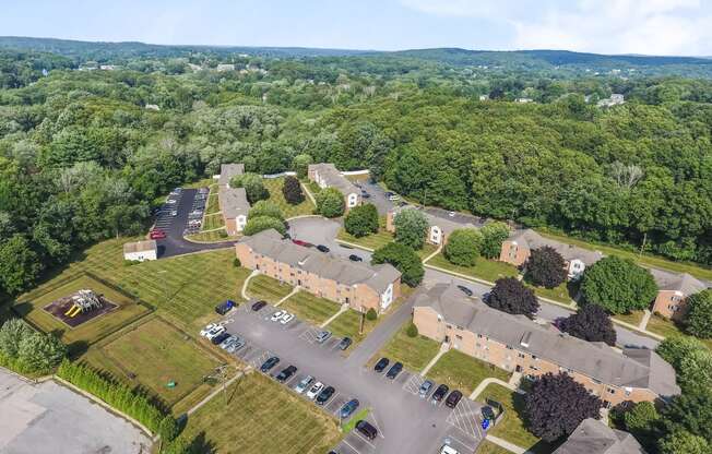an aerial view of a neighborhood with cars parked in a parking lot