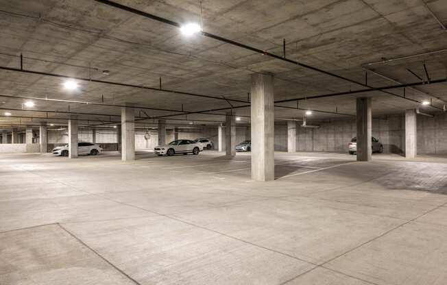 an empty parking garage with cars parked in it