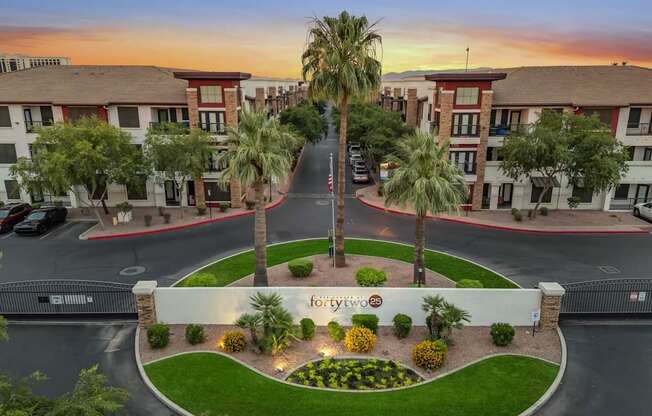 A beautifully landscaped entrance to a Forte 2 apartment complex.