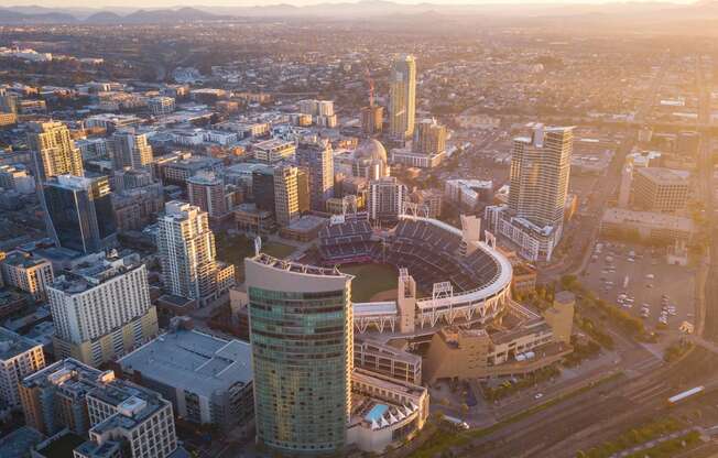 an aerial view of a city with a baseball stadium