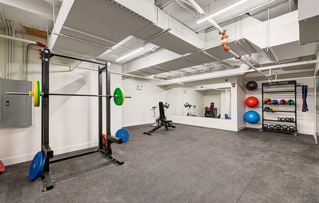 a workout room with weights and other exercise equipment in a large space