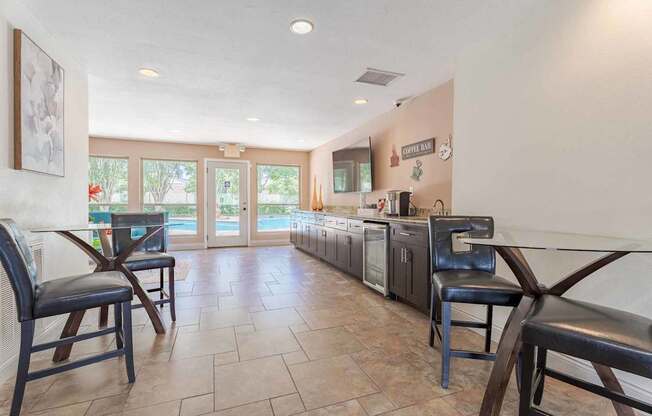 A kitchen with a tile floor and a dining table with chairs.