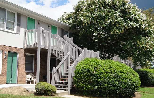 the outside of an apartment building with stairs