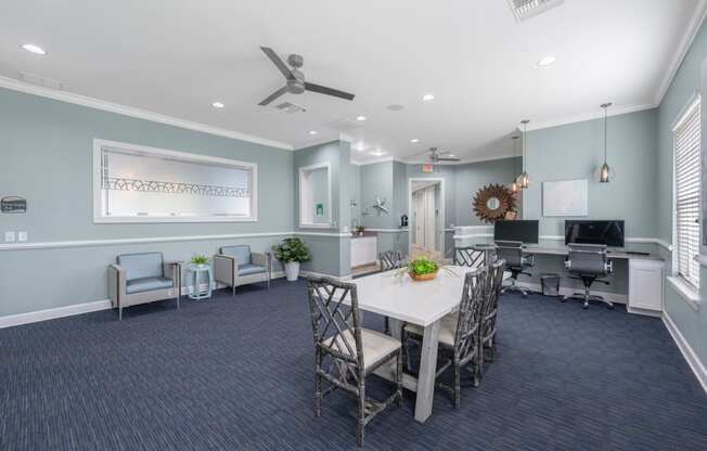 a conference room with a white table and chairs