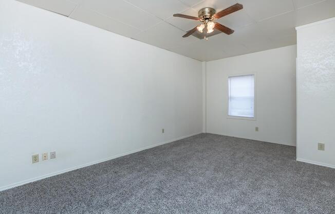 a bedroom with a ceiling fan