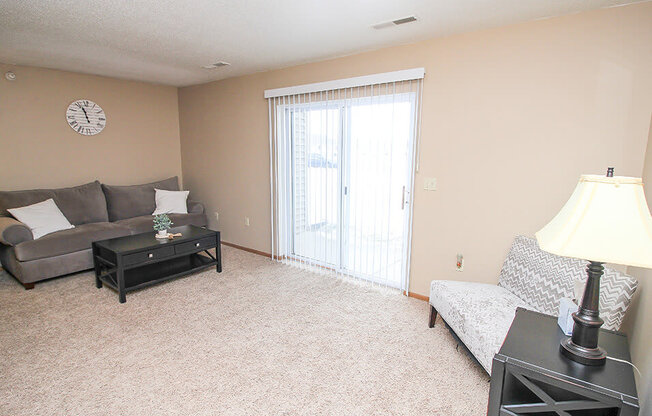 a living room with a sliding glass door