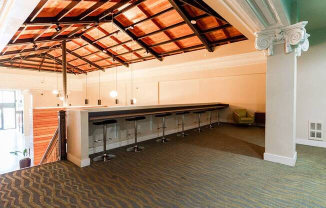A room with a bar and a carpeted floor at Addison on Fourth Apartments, Washington, 98104