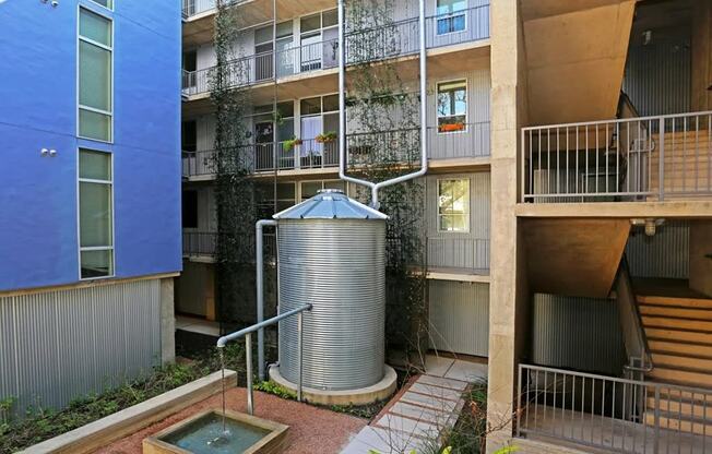 an apartment building with a water tank in the middle of it