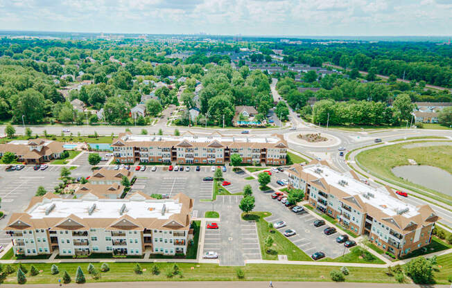 an aerial view of an apartment complex and parking lot