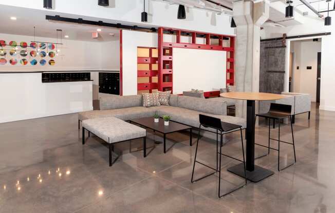 a living room with couches tables and chairs and a wall with artwork