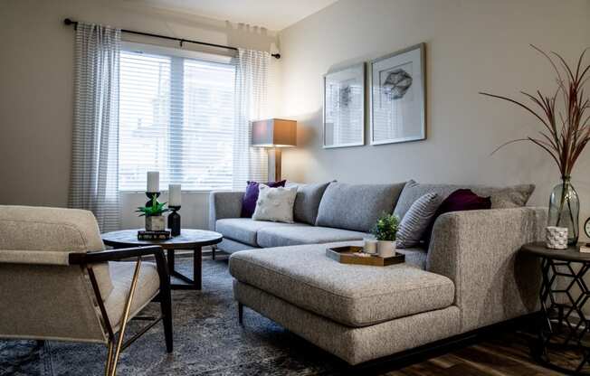 a living room with couches and chairs and a table at 310 at Nulu Apartments-Student, Kentucky, 40202