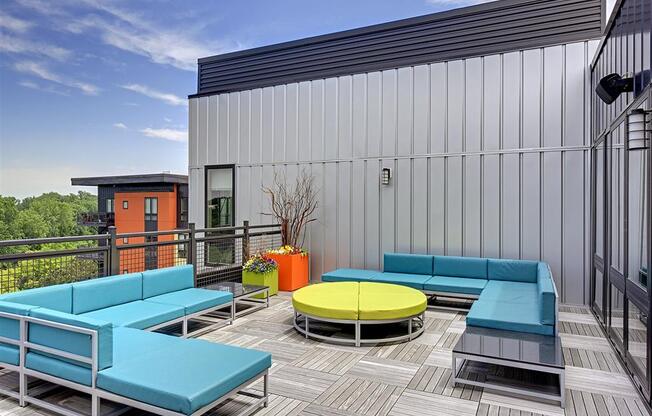 Be @ Axon Green Rooftop Patio lounge area with blue couches and green sofa table