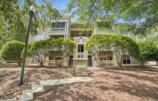 A house with a front yard and a tree in front of it at Beacon Ridge Apartments, PRG Real Estate Management, Greenville, 29615
