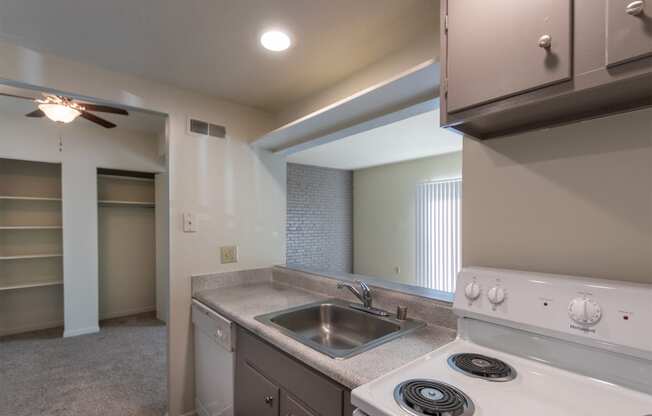 This is a photo the dining area and living room from the kitchen of the 833 square foot Chestnut, 2 bedroom apartment at Montana Valley Apartments in Cincinnati, OH.