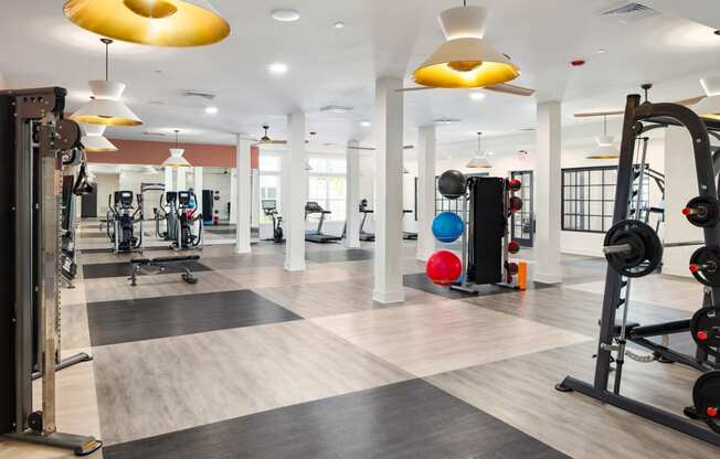 a gym with colorful lights on the ceiling at The Quincy Apartments, Georgia, 30102