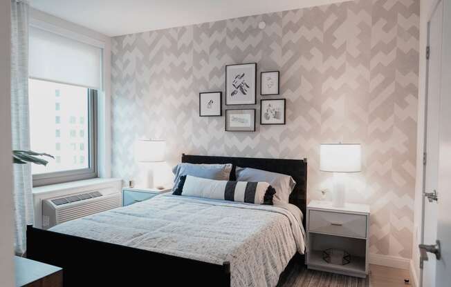 a bedroom with a bed and pictures on the wall at The Lively, Jersey City