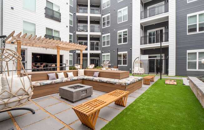 A patio with a fire pit and seating area.