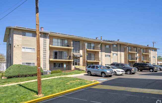 A parking lot in front of apartment buildings.