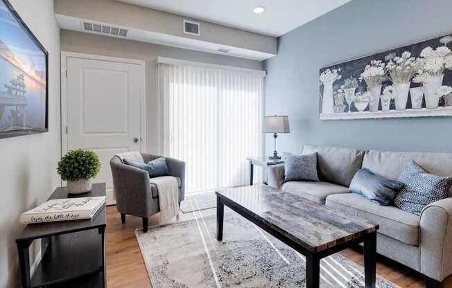 a living room with a couch and a table. Circle Pines, MN Lexington Lofts