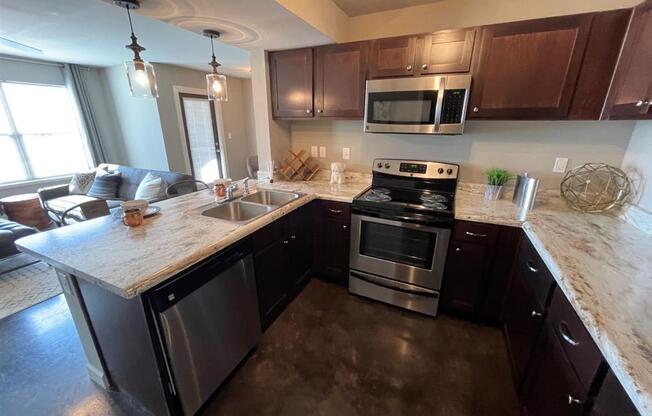 a kitchen with stainless steel appliances and a marble counter topat Palisades at Pleasant Crossing, Arkansas