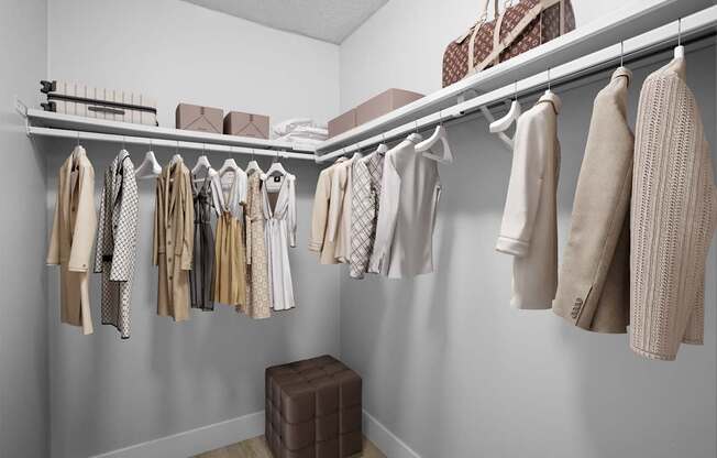 A closet with a variety of clothes hanging on a rail.