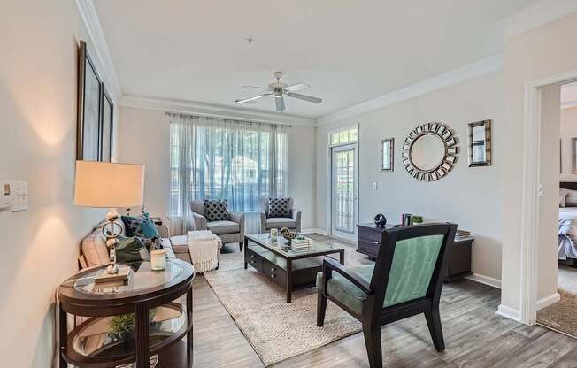 A living room with a dark wood floor and furniture.