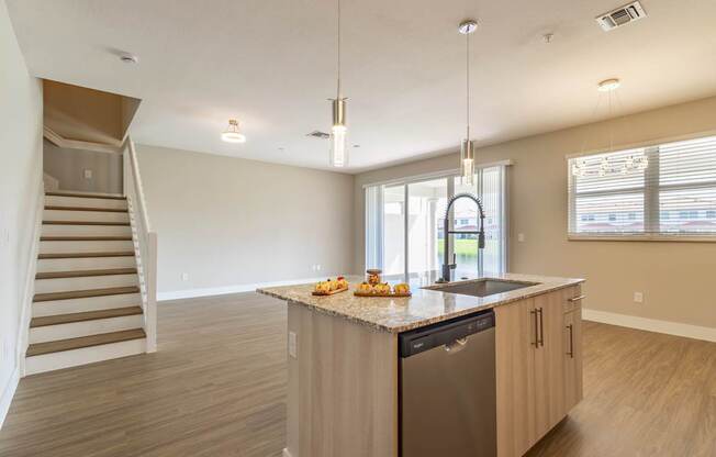 A kitchen with a dishwasher and a counter with food on it.