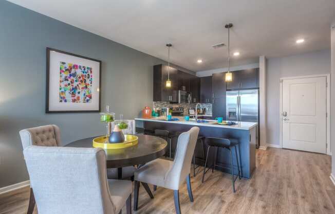 a kitchen and dining area with grey walls
