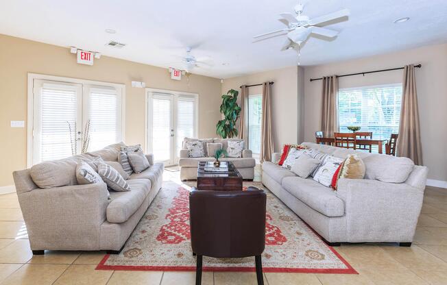 a living room filled with furniture and a large window