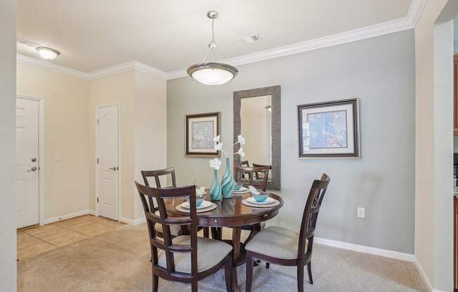 A dining room with a table set for two.